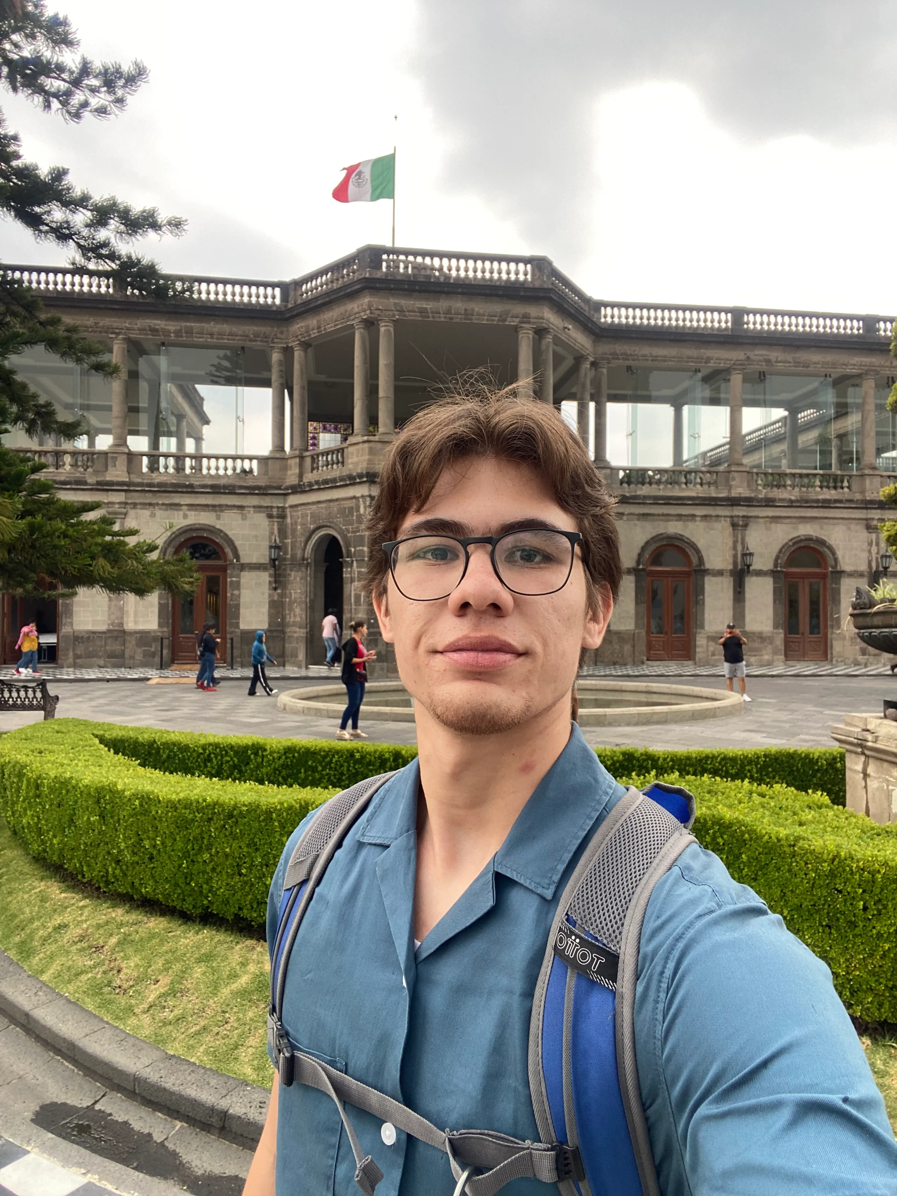 selfie of juan, smiling and with the capultepech castle behind